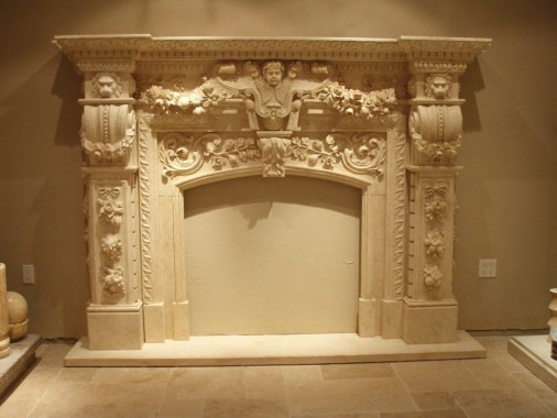 Decorative carved stone fireplace mantel surround