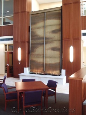Large indoor burlwood sandstone wall fountain
