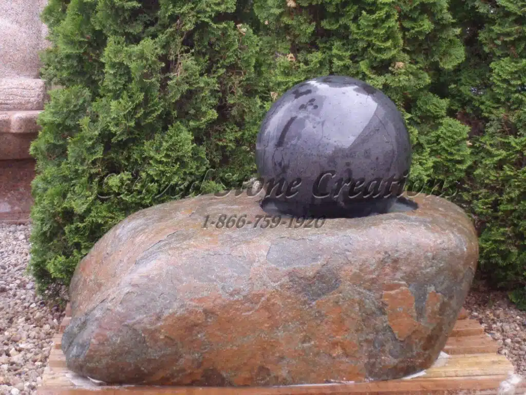 Boulder fountain with black sphere