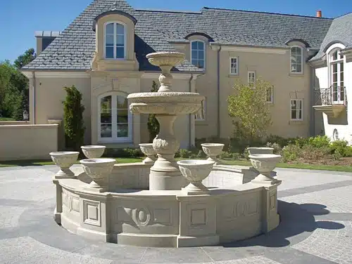 Outdoor large fountain with eight carved stone planters.