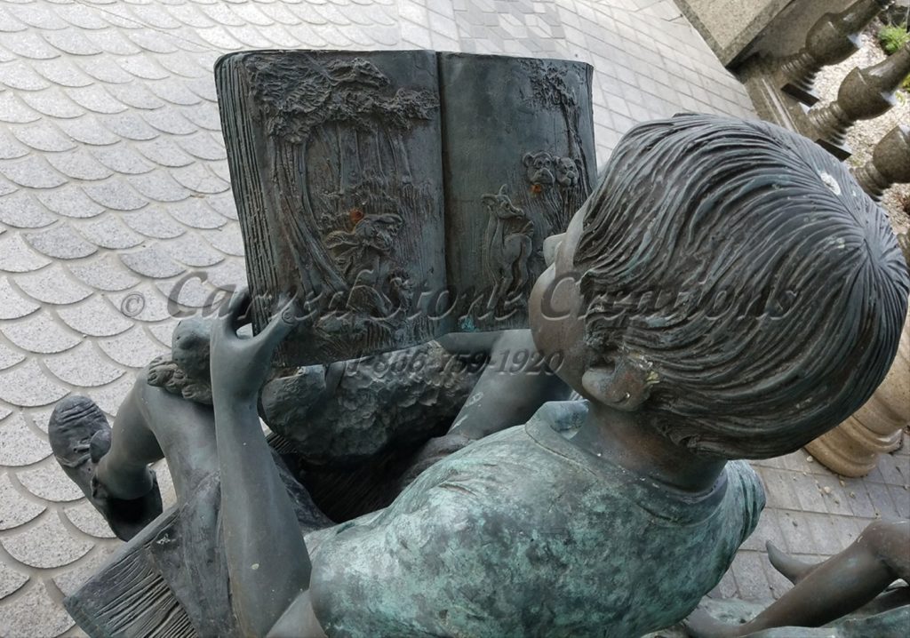 Bronze boy statue with Dog and Reading the Book on Bench