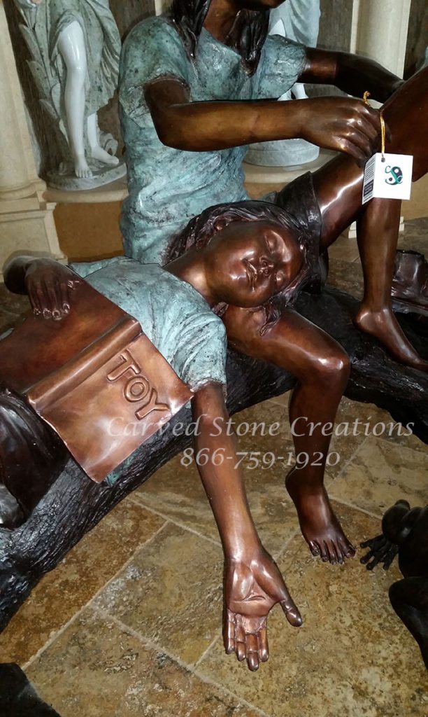 sleeping bronze statue with other statue reading book