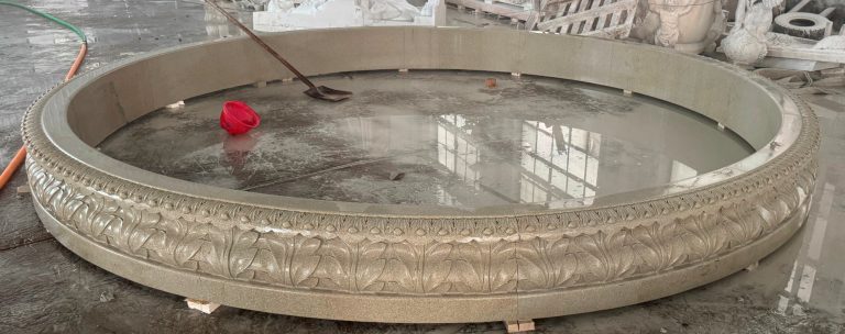 14' diameter x 14" tall relief carved pool surround, carverd of golden cyrpess granite