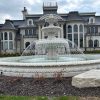 This is an example of an acatnhus relief carved pool surround with a tiered fountain and copper spray ring.