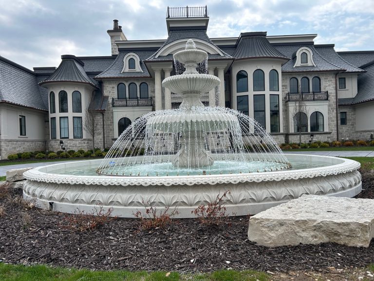 This is an example of an acatnhus relief carved pool surround with a tiered fountain and copper spray ring.
